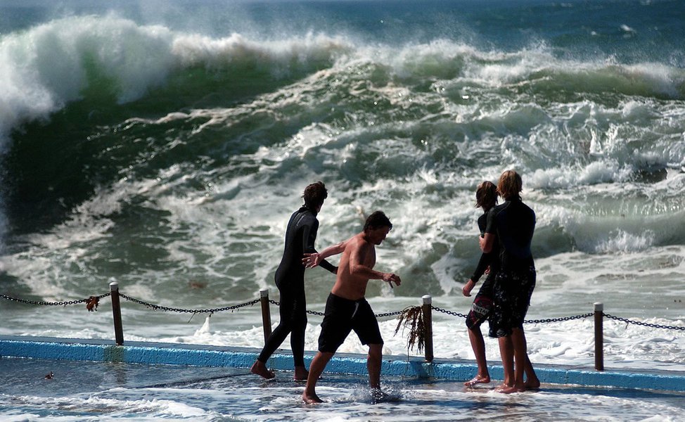 Swimmers at Dee Why on Sydney's northern beaches make the most of the large waves caused by Cyclone Wati, Tuesday, March 28, 2006. (AAP Image/Jeremy Piper) 