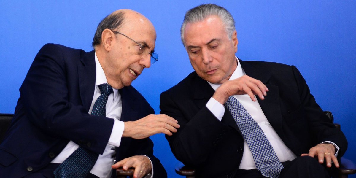 Brazilian Finance Minister Henrique Meirelles (L) and acting President Michel Temer attend a meeting 