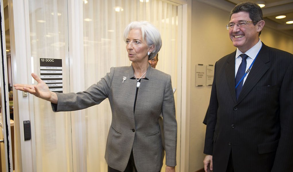 International Monetary Fund Managing Director Christine Lagarde (L) greets Brazil's Finance Minister Joaquim Levy (R) April 16, 2015 at the IMF Headquarters in Washington, DC. T IMF Staff Photo/Stephen Jaffe