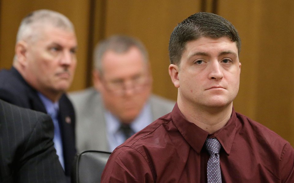 Officer Michael Brelo listens during court proceedings Wednesday, Dec. 17, 2014, in Cleveland. Brelo faces two counts of aggravated manslaughter, which are felonies, after being accused of jumping on the hood of the suspects' car and firing the final 15 s