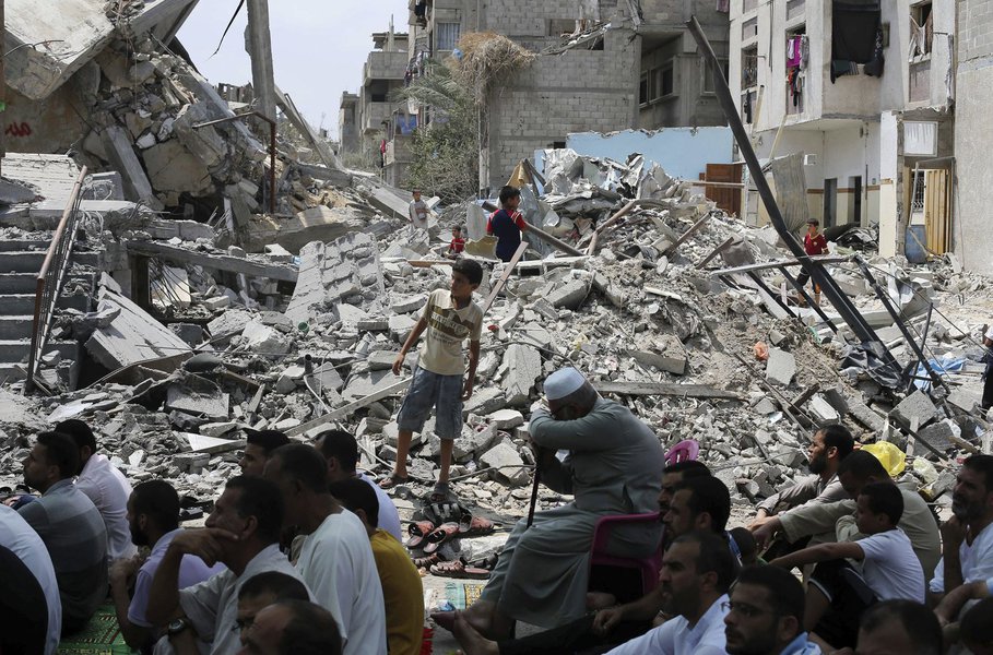 Palestinos rezam perto de restos de mesquita na Faixa de Gaza nesta sexta-feira.  REUTERS/Ibraheem Abu Mustafa