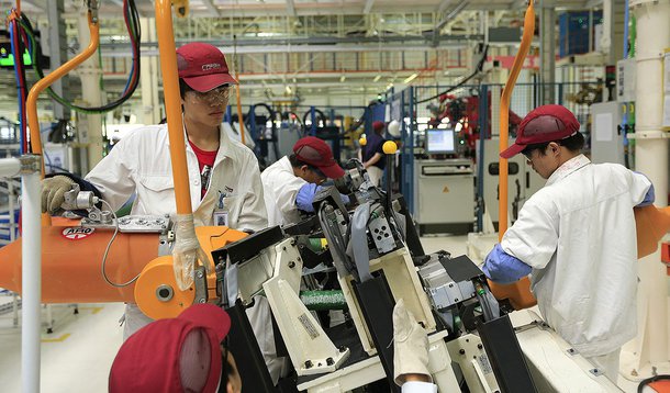 Employees at the Fiat SpA and Guangzhou Automobile Group Co. (GAC) manufacturing plant work on the production of Viaggio vehicles in Changsha, Hunan Province, China, on Thursday, June 28, 2012. Fiat, with two failed partnerships in China, returned to manu