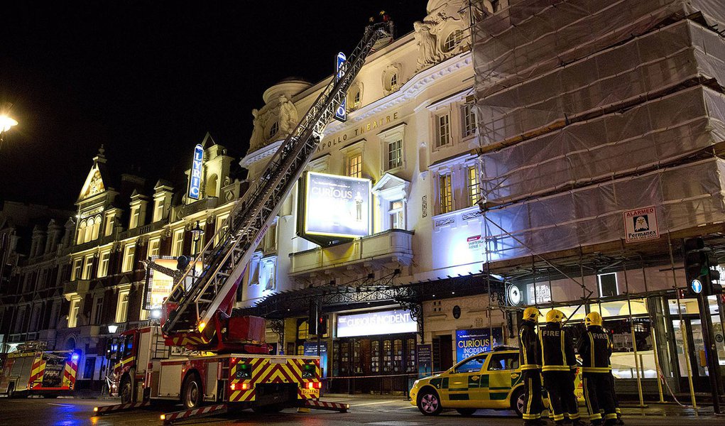 Emergency services look at the roof of the Apollo Theatre on Shaftesbury Avenue after part of the ceiling collapsed in central London December 19, 2013.  Emergency services said nearly 90 people had been injured in a packed London theatre on Thursday when