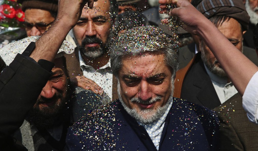Supporters of Afghan presidential candidate Abdullah Abdullah throw shreded paper on his head as they welcome him during a campaign rally in Deh Sabz district on the outskirts of Kabul, Afghanistan, Wednesday, March, 5, 2014. Eleven Afghan presidential ca