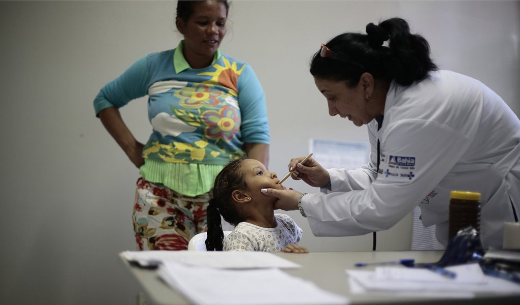 Cuban doctor Dania Rosa Alvero Pez examines a young patient at the Health Center in the city of Jiquitaia in the state of Bahia, north-eastern Brazil, November 18, 2013.  They were heckled and called slaves of a communist state when they first landed, but