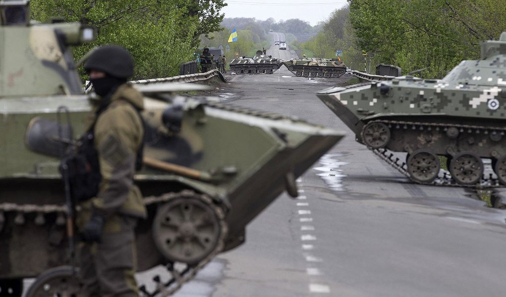 A Ukrainian soldier stands guard in front of armoured personnel carriers at a check point near the village of Malinivka, southeast of Slaviansk, in eastern Ukraine April 29, 2014. REUTERS/Baz Ratner (UKRAINE - Tags: POLITICS CIVIL UNREST)