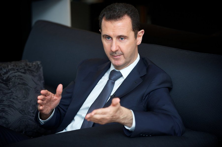 Syria's president Bashar al-Assad gestures during an interview with French daily Le Figaro in Damascus in this handout distributed by Syria's national news agency SANA on September 2, 2013.  REUTERS/SANA/Handout (SYRIA - Tags: CONFLICT CIVIL UNREST POLITI