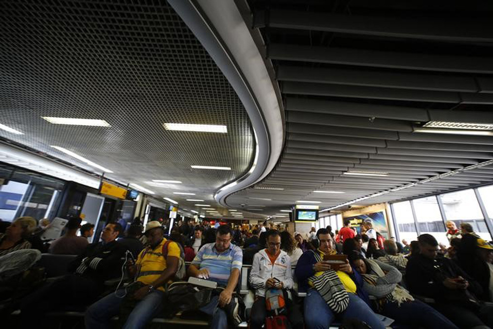 Passengers wait for their delayed flights at Alfonso Pena airport in Curitiba city, June 17, 2014. In a project called 'On The Sidelines' Reuters photographers share pictures showing their own quirky and creative view of the 2014 World Cup in Brazil. REUT