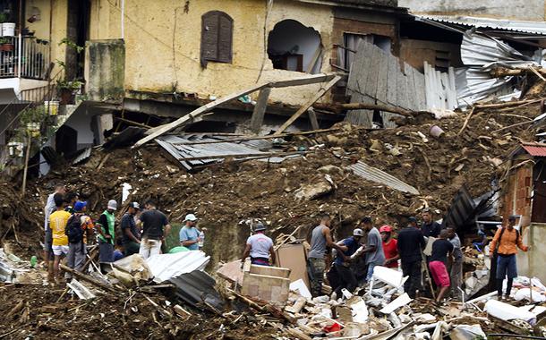 Bombeiros, moradores e voluntários trabalham no local do deslizamento no Morro da Oficina, após a chuva que castigou Petrópolis, na região serrana fluminense