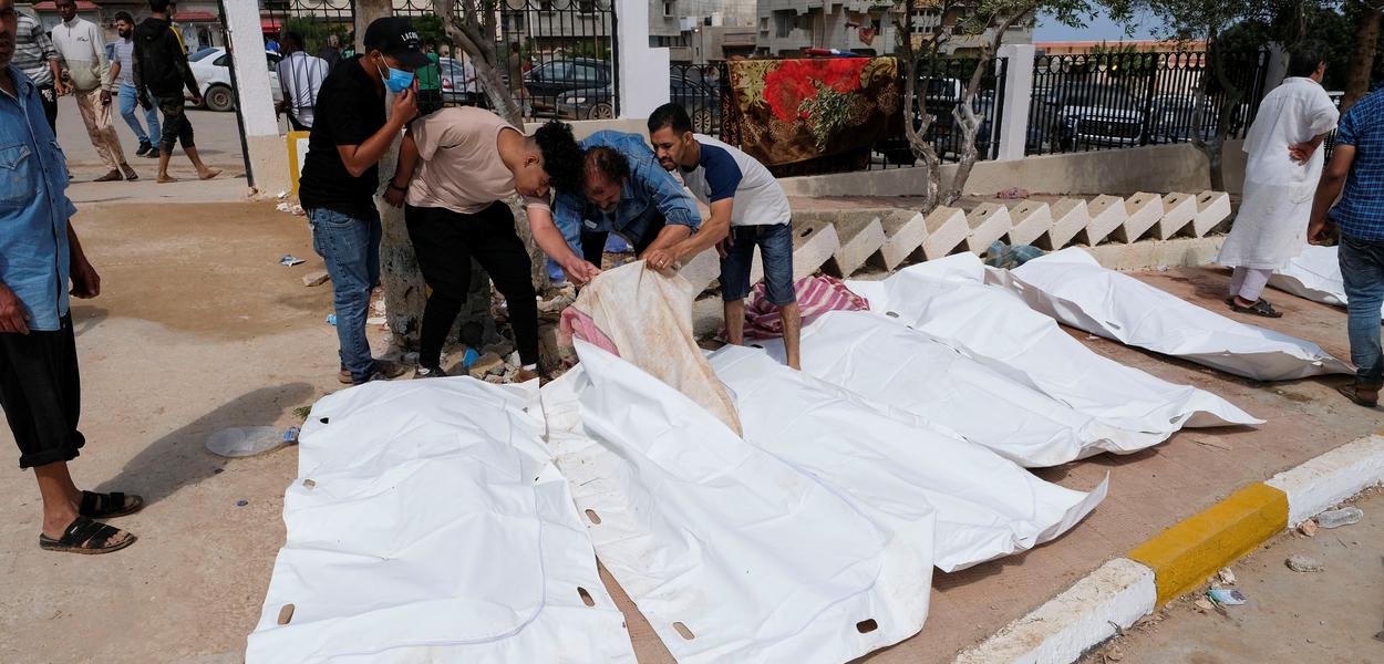 Pessoas tentam identificar corpos do lado de fora de hospital em Derna, na Líbia
