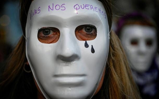 Mulher do movimento “Nem uma (mulher) a menos” usa máscara durante marcha ao Congresso em protesto contra feminicídios e violência de gênero, em Buenos Aires, Argentina. A máscara diz: "Queremos-nos vivas"
