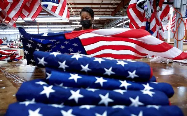 FILE PHOTO: Barbara McClorin inspects U.S. flags made at Valley Forge Flag’s manufacturing facility in Lane, South Carolina, U.S., February 22, 2024. REUTERS/Evelyn Hockstein/File Photo