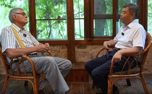 O professor Wang Yuanfeng, diretor do Centro de Pesquisa de Tecnologias e Estratégias de Carbono Neutro da Universidade Jiaotong de Beijing, conversa com Patrick Nijs, ex-embaixador da Bélgica na China