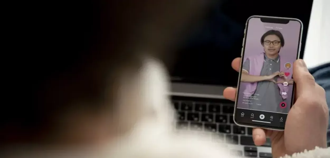 Mulher assiste a um vídeo de rede social em smartphone