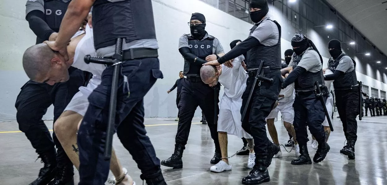 Guardas prisionais salvadorenhos escoltam supostos membros da gangue venezuelana Tren de Aragua e da gangue MS-13 deportados pelo governo dos EUA em Tecoluca, El Salvador, 31/03/2025