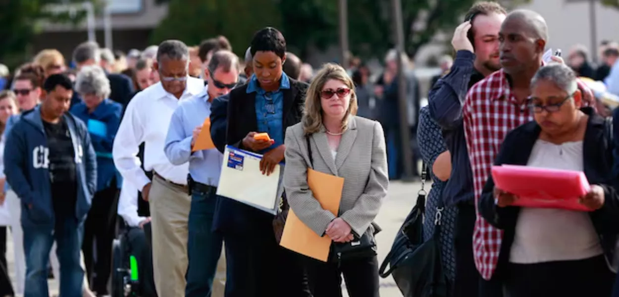 Pessoas esperam na fila para entrar em feira de empregos