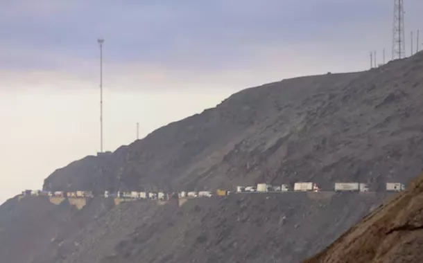 Uma imagem mostra veículos estacionados em uma estrada montanhosa enquanto mineradores de pequena escala interrompem o tráfego para exigir a extensão de um programa que lhes permite operar temporariamente, mas que as autoridades dizem ter expandido a mineração ilegal, em Ocona, Peru, 27 de novembro de 2024