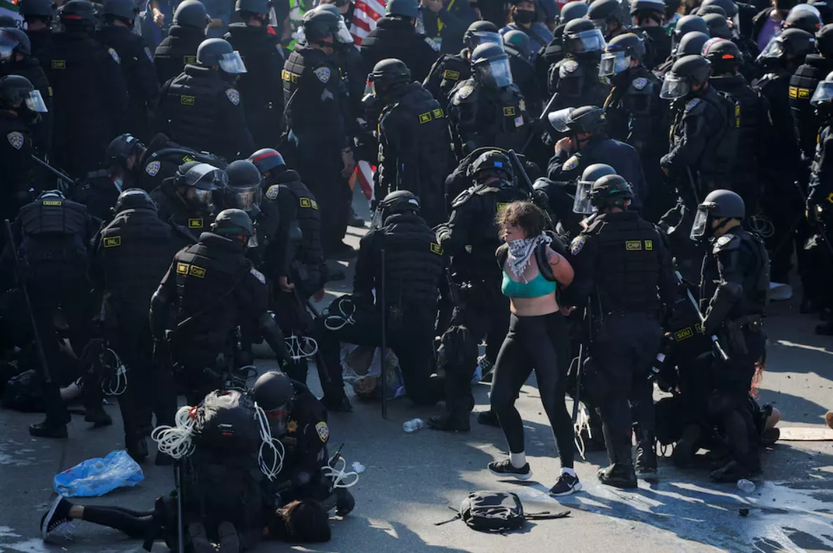 Policiais detêm manifestantes durante um protesto contra as varreduras federais de imigração, no centro de Los Angeles, Califórnia, em 8 de junho
