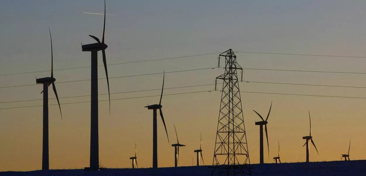 Usinas eólicas e torre de transmissão de energia