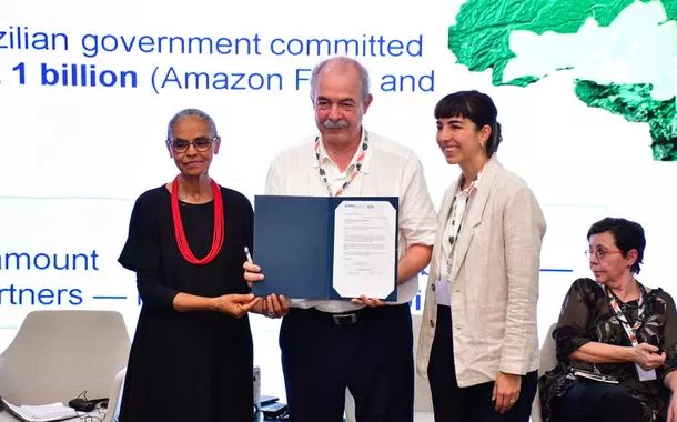 Aloizio Mercadante, ao lado de Marina e de Beatriz Lutz, da Pátria Investimentos, exibe contrato da operação de crédito.