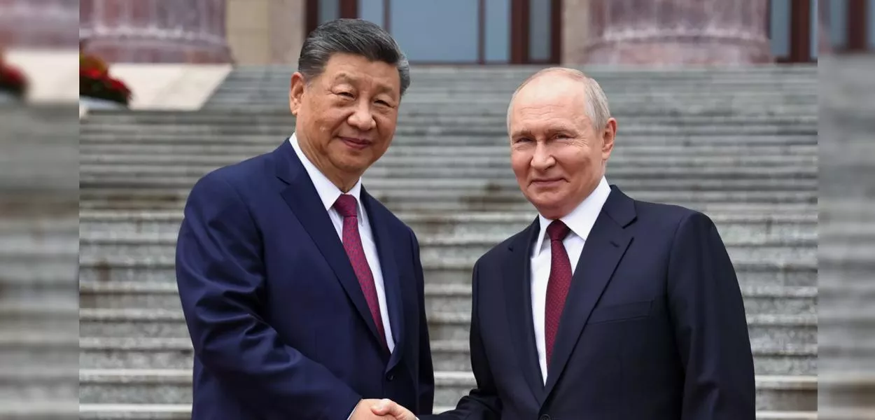 Pesidente russo Vladimir Putin (à direita) e o presidente chinês Xi Jinping apertam as mãos durante uma cerimônia de boas-vindas no Grande Salão do Povo, em Pequim, China, na quarta-feira, 20 de maio de 2026.